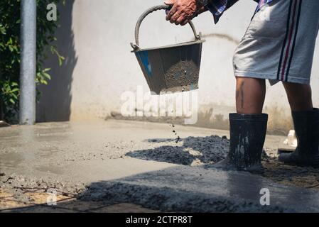 Construction workers helped cement bucket loaders to be introduced into a points set. Stock Photo