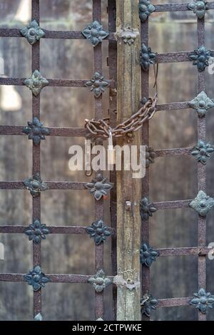 Closed lock with a chain on an old steel door, locks on rusty metal door Stock Photo