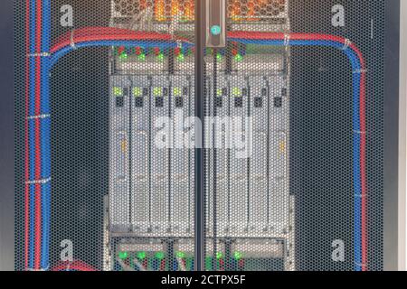 Rack Mounted Servers In A Server Room, Server rack audio cable. Severs computer in a rack at the large data center. Stock Photo