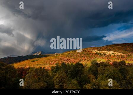 Thunderstorm in the mountains.  Quick and sometimes violent thunderstorms can develop over the high mountains of Utah, USA in the Fall. Stock Photo
