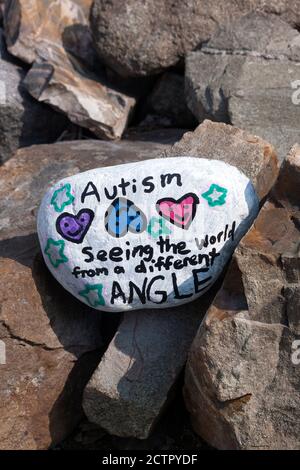 Painted rock with inspirational message about Autism. Stock Photo