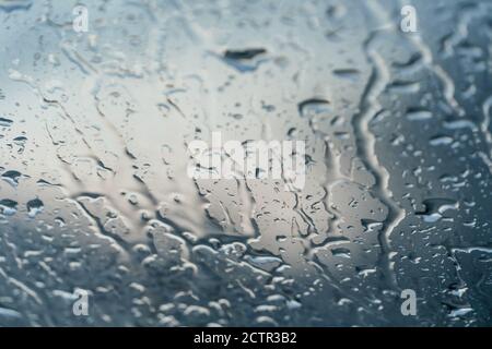 Background of water droplets on the windshield on a rainy evening with sun patterns Stock Photo