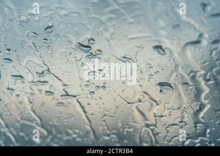 Background of water droplets on the windshield on a rainy evening with sun patterns Stock Photo