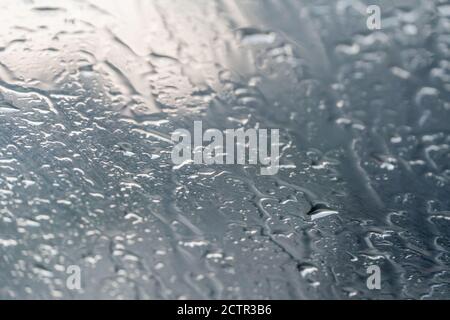 Background of water droplets on the windshield on a rainy evening with sun patterns Stock Photo
