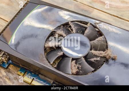 Dusty video card from a computer close up on a wooden background Stock Photo