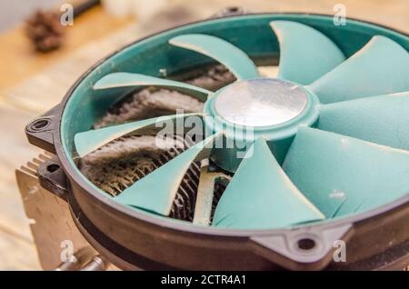 Dusty green cooler from the computer on a wooden table close up Stock Photo