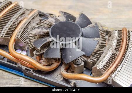 Dust on CPU cooler video card computer close up on wooden table Stock Photo