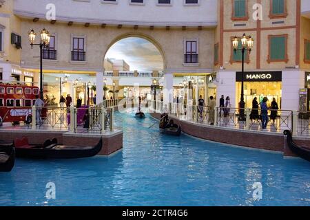 venice canal in Villaggio Mall, shopping center in Aspire Zone. Luxury brands, expensive stores and exclusive shops in Doha shopping mall in venetian Stock Photo