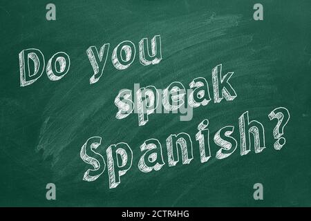 Hand drawing 'Do you speak Spanish?' on green chalkboard Stock Photo