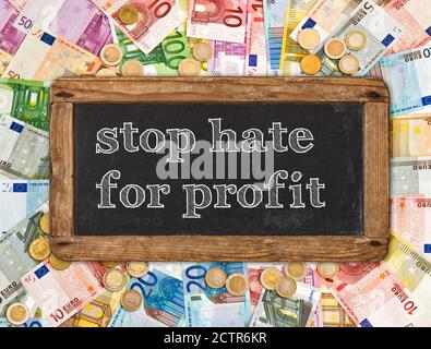 Money background with chalkboard. Stop hate for profit Concept Stock Photo