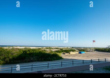 The Beach With a Wooden Fence and Sand Dunes Covered in Plants in Wildwood New Jersey Stock Photo
