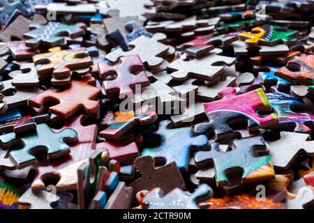 Disassembled puzzle colored pieces Stock Photo