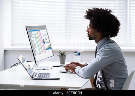 Analyst Employee Working With Spreadsheet On Computer Stock Photo