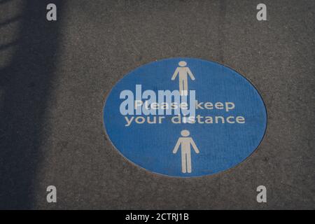 Please keep your distance social distancing sign due to Coronavirus pandemic on a pavement in London, UK. Stock Photo