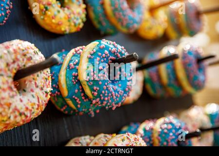 Assorted donuts on a wand. Dessert colorful snack Stock Photo