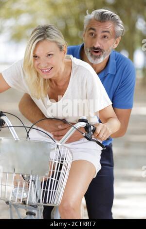 happy couple going for a bike ride in the city Stock Photo