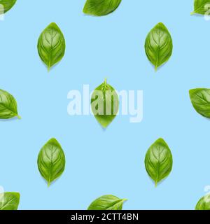 Italian Basil leaf herb seamless pattern on blue background, Creative seamless pattern made from fresh green basil flat lay layout. Stock Photo