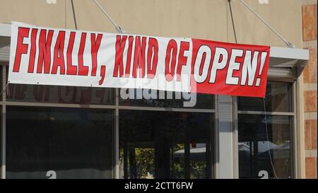 Humorous reopening sign on a store during times of Covid-19 shutdowns Stock Photo