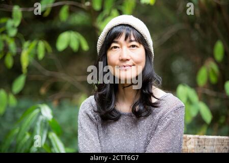 Japanese woman sitting in garden Stock Photo