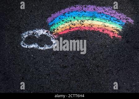 Childs chalk drawing with cloud and rainbow Stock Photo