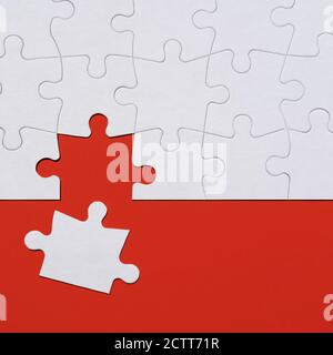 Last puzzle piece in jigsaw puzzle on red background Stock Photo