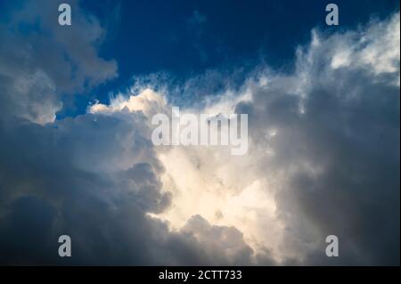 Cumulus clouds lit by sun Stock Photo