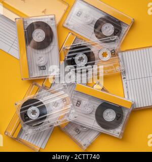 Analog audio cassettes on yellow background Stock Photo