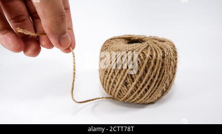 Roll of jute twine for crafting on white background Stock Photo