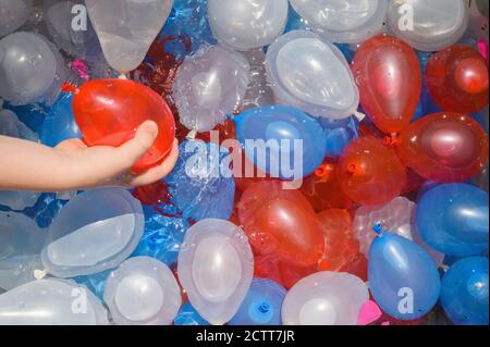 Close up of boy (4-5) playing with water balloons Stock Photo