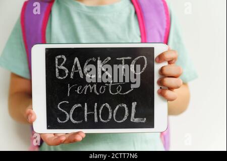 Child (6-7) holding digital tablet showing message Stock Photo