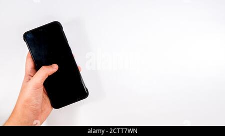 Holding a phone on hand on white background Stock Photo