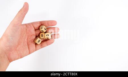 Rolling of wooden dice on hand Stock Photo