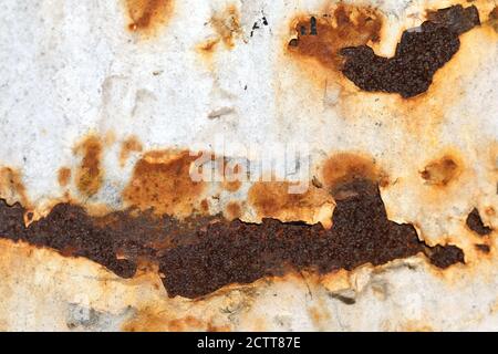 Rusty peeling painted white metal background wall with rust spots. Stock Photo