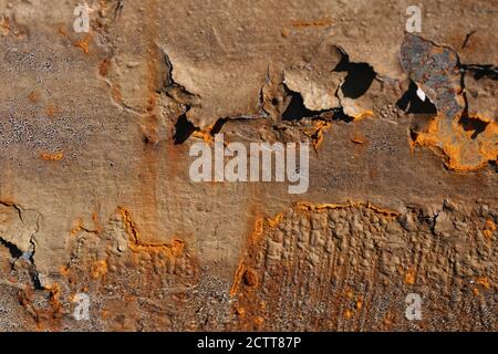Brown painted rusty metal surface with streaks of rust. cracked rusty corrosion, oxidized iron background. Stock Photo