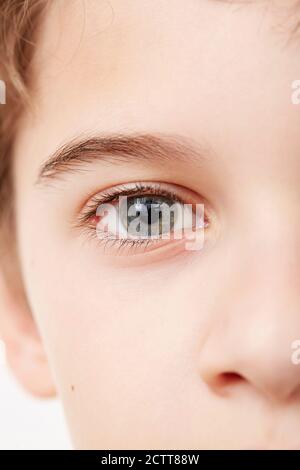 Close up of face of boy (8-9) with blue eyes Stock Photo