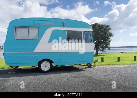 Small retro style caravan parked on Tauranga waterfront. Stock Photo