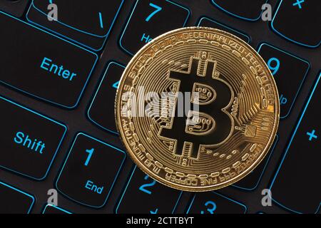 Bitcoin on laptop keyboard, top view. Digital currency close up Stock Photo