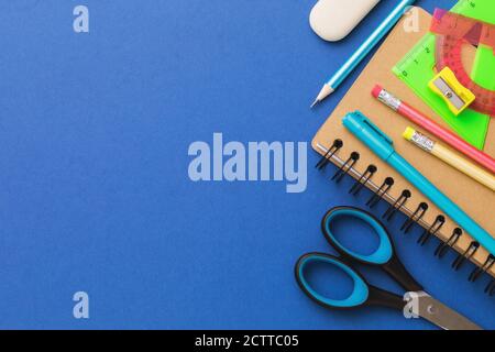 Various school supplies on a blue background with copy space, top view Stock Photo