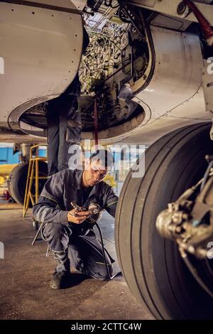 Aircraft Repair. Technician Checking Plane Jet Engine For Safety Stock ...