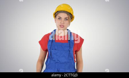Woman in construction outfit talking to camera while walking on Stock Photo