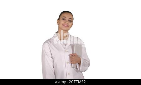 Woman doctor walking with tablet in hands on white background. Stock Photo