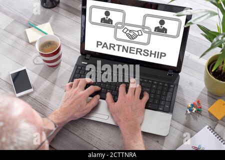 Business partnership concept shown on a laptop used by a man Stock Photo