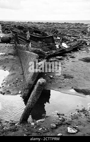 Remains of ship (after shipwreck) at Hunstanton beach, Norfolk, UK. Black white photo. Stock Photo