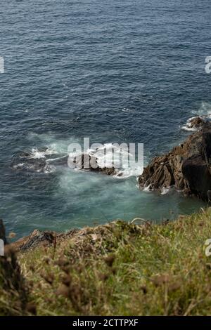 Wave crashing against Headland at Tintagel Castle, Cornwall Stock Photo