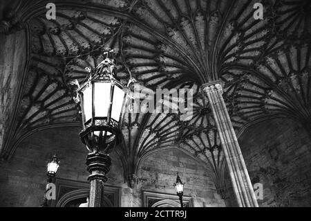 OXFORD, UK - AUGUST 23, 2017: Lanterns and beautiful fan vaulted ceiling in Christ Church college of the University of Oxford in England. Black and wh Stock Photo