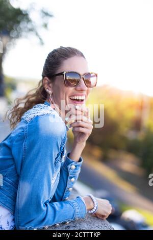 Happy 30s urban woman laughing in park on jokes, good mood Stock Photo
