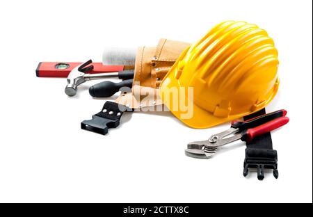 Contractor's equipment. Yellow hard hat with tools, isolated on white background. Stock Photo