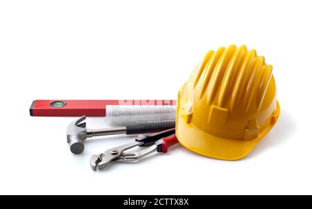 Contractor's equipment. Yellow hard hat with tools, isolated on white background. Stock Photo