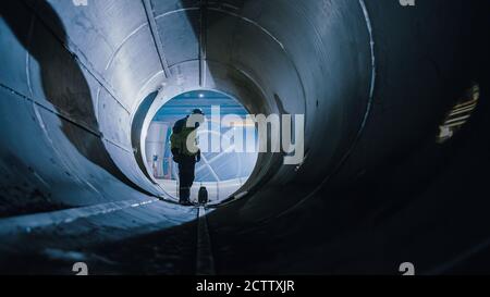 Professional Heavy Industry Welder Working Inside Pipe. Construction of the Oil, Natural Gas and Fuels Transport Pipeline. Industrial Manufacturing Stock Photo