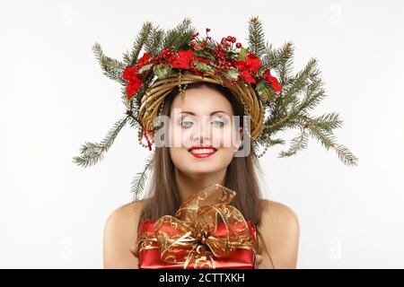 Beautiful christmas woman with gift in hand. Winter holiday Stock Photo